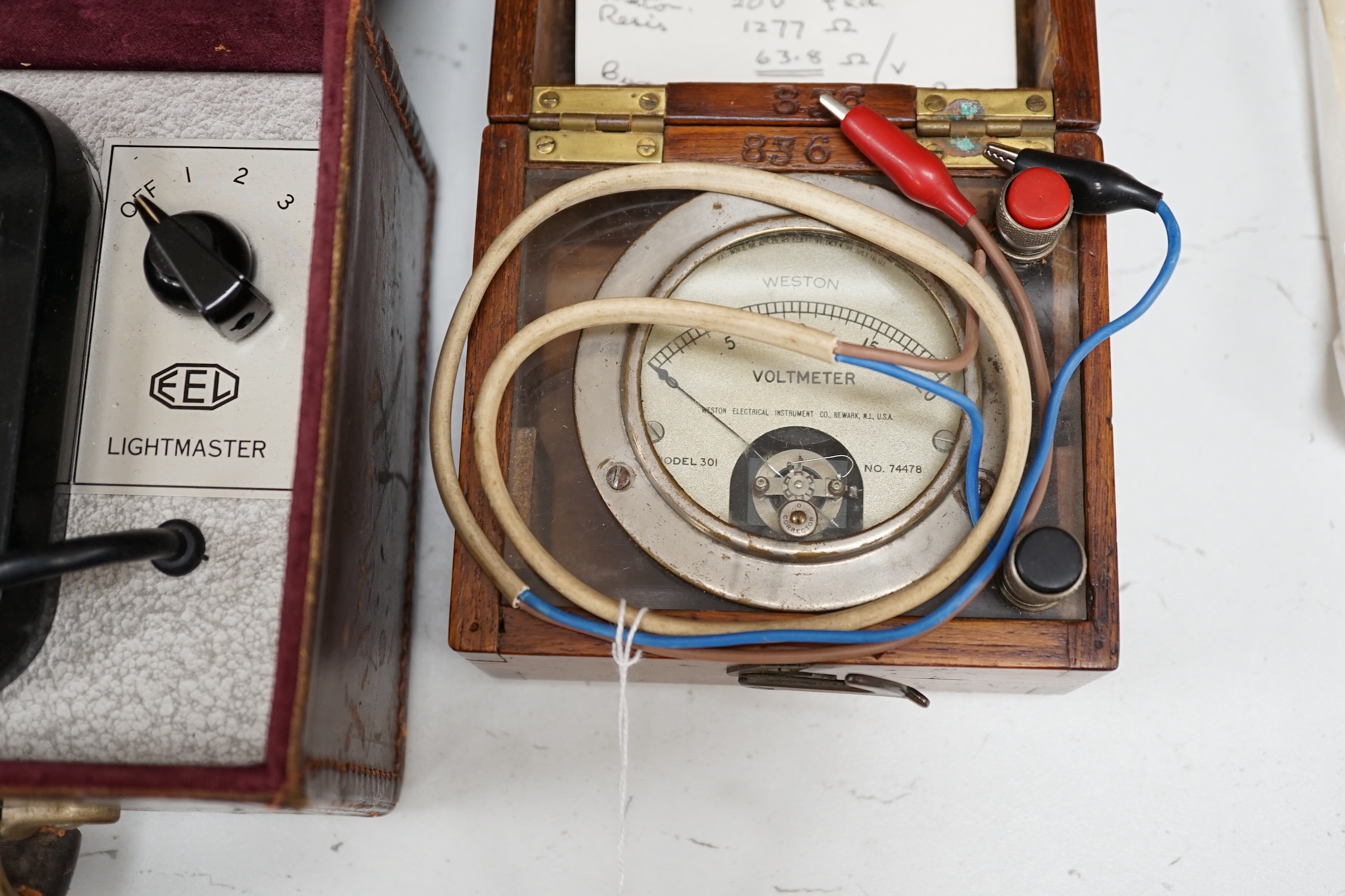 A writing slope, humidor and contents including a silver mounted cigar case, an Evans Electroselenium Ltd. light meter and a Weston Voltmeter. Condition - fair.